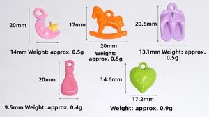 Detail view of colorful acrylic charms including moon star and horse with size measurements