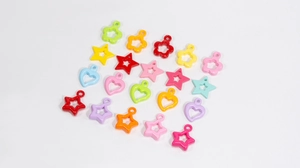 Macro shot of colorful star and heart-shaped pendants for DIY jewelry making