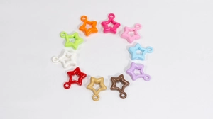 Close-up of ten colorful star-shaped hollow pendants with glossy finish for DIY jewelry