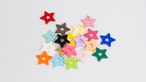 Detailed macro view of hollow five-pointed star charms in various macaron colors for DIY jewelry