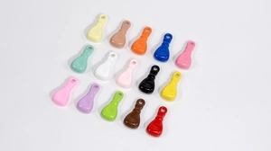 Close-up of colorful acrylic bowling pin charms for DIY jewelry and keychains