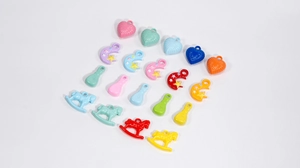 Close-up of colorful acrylic moon and star pendants for DIY keychain jewelry making