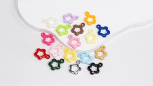 Flat lay of colorful 16*21mm star flower charms for DIY jewelry making accessories