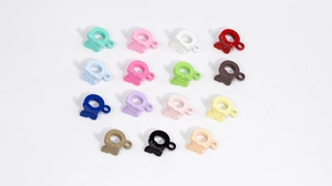 Detailoverzicht van vlinderhangers in vijftien verschillende macaronkleuren voor DIY-sieraden