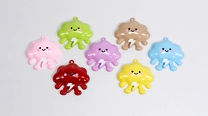 Detail view of seven colorful cartoon cloud charms with smiling faces for DIY crafts