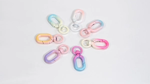Macro view of eight colorful macaron gradient alloy swivel snap hooks for DIY crafts