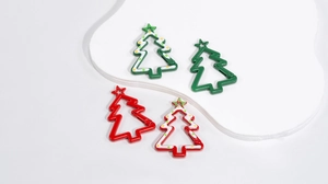 Detail of red and green Christmas tree spring hooks with star openings and dots
