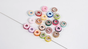 Close-up of colorful acrylic donut beads with frosting detail for DIY jewelry making