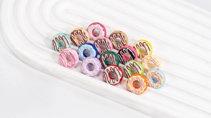 Detailed macro shot of colorful acrylic donut beads with frosting for DIY jewelry