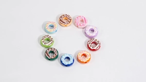 Flat lay of colorful acrylic donut beads in various shades for DIY jewelry making crafts