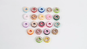 Macro detail of assorted colorful acrylic donut beads with sugar sprinkles for DIY jewelry