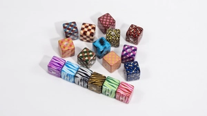 Close-up of acrylic cube beads with leopard and checkerboard prints for DIY jewelry