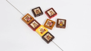 Detailed view of square cartoon bear beads for DIY jewelry with through-hole design