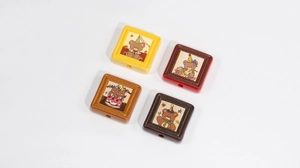Macro view of four colorful resin square bear beads for DIY jewelry and phone chains