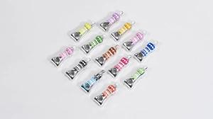 Close-up of colorful alloy paint tube pendants with love engraving for DIY jewelry making