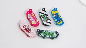 Detailed top view of five colorful acrylic mini skateboard pendants with graffiti prints