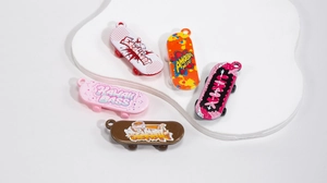 Close-up of colorful acrylic mini skateboard pendants with street style graffiti patterns