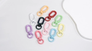 Macro detail of colorful glitter lobster clasps and metal spring hooks for DIY crafts