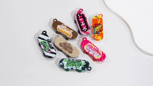 Detailed top view of various colorful acrylic skateboard pendants with graffiti patterns
