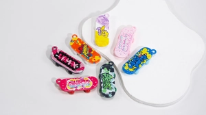 Set of 6 mini colorful acrylic skateboards with diverse graffiti art designs on white surface