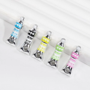 Five colorful paint tube acrylic charms with hearts and love text for DIY jewelry making