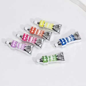 Set of six colorful acrylic paint tube charms with love text for DIY jewelry making
