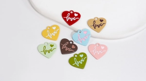 Detail of colorful alloy heart charms with embossed Love text for DIY accessories