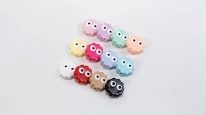 Close-up of assorted colorful acrylic beads with cartoon eyes for DIY jewelry making