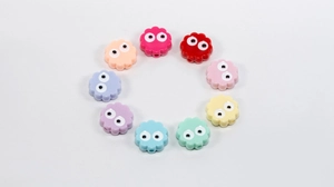 Colorful flower acrylic beads with eye design arranged in a circle for DIY jewelry