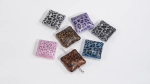 Detailed view of colorful acrylic leopard print square beads for DIY jewelry making