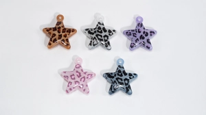 Macro shot of colorful acrylic leopard print star pendants for DIY jewelry crafting
