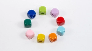 Colorful acrylic cube beads arranged in a circle for DIY jewelry and keychain making