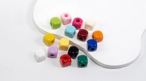Macro view of colorful acrylic square beads with large holes for DIY jewelry making