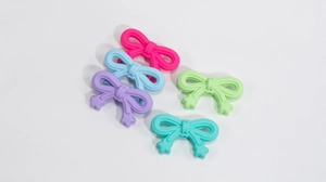 Flat lay of colorful acrylic bow beads with star detail for DIY keychain jewelry making