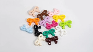 Detailed top view of colorful acrylic bow beads for DIY phone chains and jewelry
