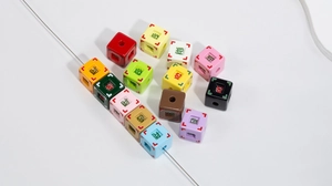 Detail of colorful acrylic cube beads with Chinese fortune characters for DIY jewelry