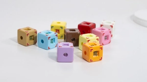 Macro shot of colorful acrylic cube beads with Chinese characters for DIY jewelry making