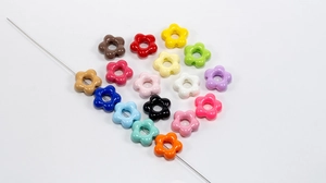 Macro view of colorful flower acrylic beads heart arrangement for DIY crafts
