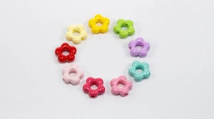 Circle arrangement of colorful acrylic flower beads for handmade jewelry DIY projects