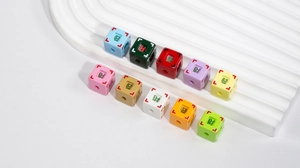 Macro detail of square acrylic beads with Chinese lucky characters for DIY jewelry making