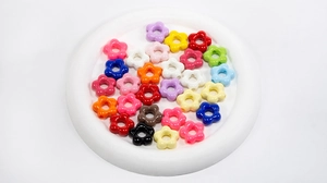 Macro detail of colorful flower acrylic beads for DIY jewelry and phone charms