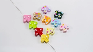 Macro detail of colorful mushroom beads with painted dots for DIY phone charms and keychains