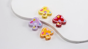 Macro shot of colorful mushroom beads with dotted patterns for DIY handmade jewelry