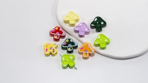 Close-up of colorful polka dot mushroom beads with pre-drilled holes for DIY jewelry