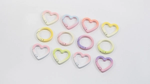 Macro view of colorful macaron heart-shaped and round zinc alloy spring carabiner clips