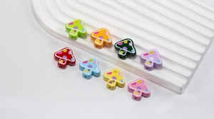 Macro detail of colorful cartoon mushroom beads for DIY jewelry and phone charms crafting