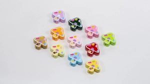 Macro shot of colorful mushroom beads with painted polka dots and base window details
