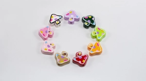 Detailed view of colorful mushroom beads with polka dots for DIY jewelry making