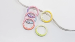 Detail of round spring snap hooks in gradient macaron colors for bag accessories