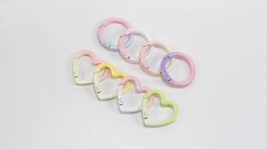 Macro detail of macaron gradient heart and round spring clasps with matte finish